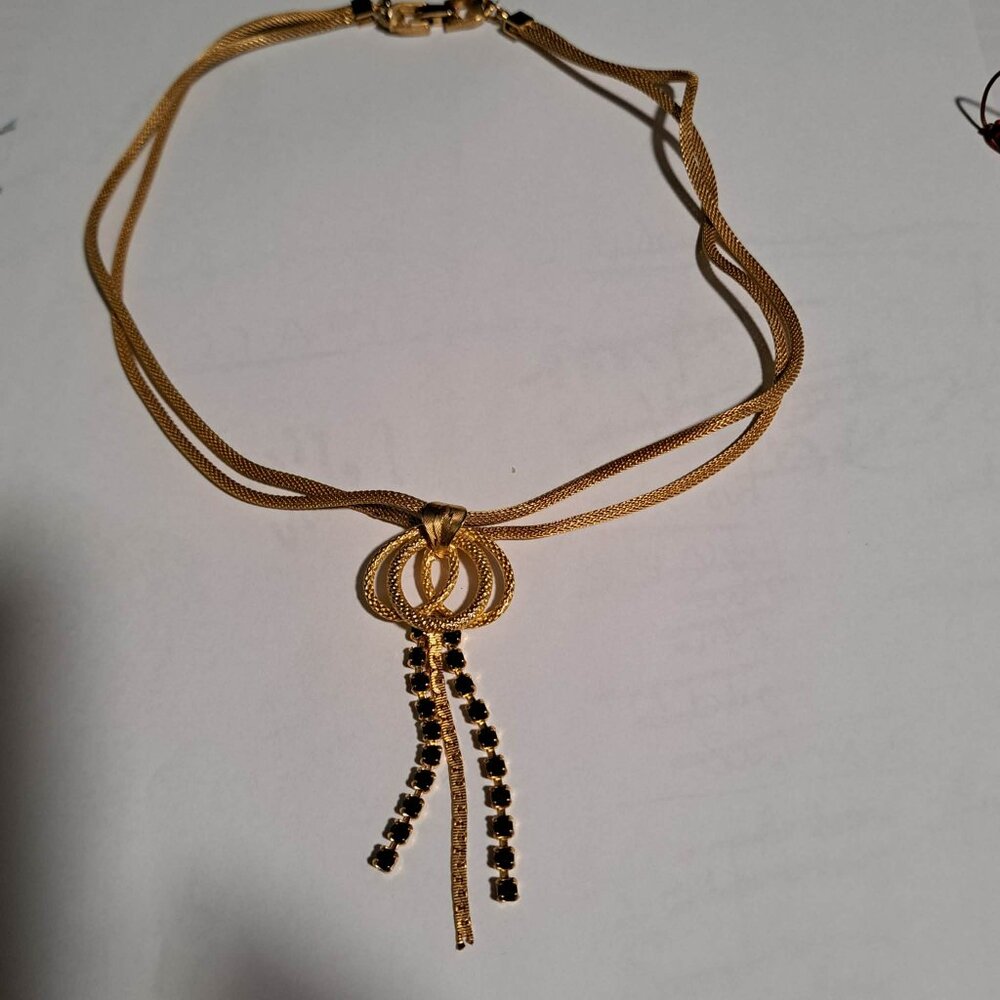 Continental gold tone necklace with black stones